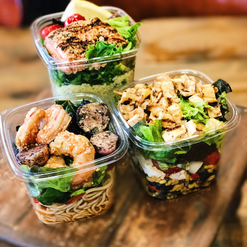takeout containers filled with chicken salad and shrimp salad