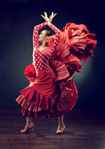 woman in red flowy dress dancing