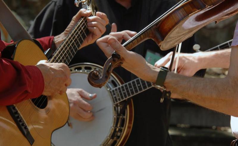 close up of people playing string instruments